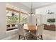 Bright breakfast nook with a round table, overlooking the screened pool area at 8800 Torey Pines Ter, Orlando, FL 32819