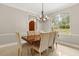 Elegant dining room featuring a wood table, upholstered chairs, and a chandelier at 8800 Torey Pines Ter, Orlando, FL 32819