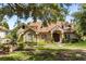 Charming brick home with a well-manicured lawn and mature trees providing ample shade at 8800 Torey Pines Ter, Orlando, FL 32819