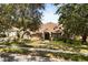 Beautiful brick home with well-maintained lawn and mature trees offering plenty of shade at 8800 Torey Pines Ter, Orlando, FL 32819