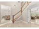 Bright foyer with staircase and views into the dining and living spaces, showcasing an open floor plan at 8800 Torey Pines Ter, Orlando, FL 32819
