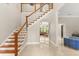 Spacious foyer with a staircase, marble floors, and a view into the living room beyond at 8800 Torey Pines Ter, Orlando, FL 32819