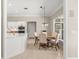 Kitchen and breakfast nook featuring white cabinets, stainless appliances, and a breakfast table at 8800 Torey Pines Ter, Orlando, FL 32819