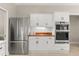 Kitchen with stainless steel appliances, white cabinets, and butcher block countertops at 8800 Torey Pines Ter, Orlando, FL 32819