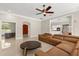 Open concept living room features a sectional sofa, round coffee table, and open doorway at 8800 Torey Pines Ter, Orlando, FL 32819