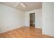 Bedroom with wood-look floors, a ceiling fan, and an ensuite bathroom, offering convenience at 9053 Lee Vista Blvd # 1404, Orlando, FL 32829