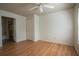 Wood-look floors, a ceiling fan, and two doorways to an ensuite bath and closet at 9053 Lee Vista Blvd # 1404, Orlando, FL 32829