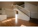 Open-concept living area with high ceilings, staircase, and wood-look floors, ideal for entertaining at 9053 Lee Vista Blvd # 1404, Orlando, FL 32829