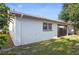 View of the backyard featuring an enclosed patio and green lawn at 10519 Wyndcliff Dr, Orlando, FL 32817