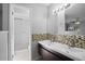 Bathroom featuring dual sinks, mosaic tile backsplash and a tiled shower at 10519 Wyndcliff Dr, Orlando, FL 32817