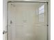 Bathroom with glass shower doors and tiled walls at 10519 Wyndcliff Dr, Orlando, FL 32817