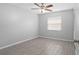 Bedroom with wood-look tile, ceiling fan and neutral colored walls at 10519 Wyndcliff Dr, Orlando, FL 32817