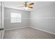This bright bedroom features wood-look tile floors, a ceiling fan, and ample natural light at 10519 Wyndcliff Dr, Orlando, FL 32817