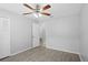 Bright bedroom features wood-look tile floors and a ceiling fan with light fixture at 10519 Wyndcliff Dr, Orlando, FL 32817