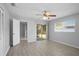 Bedroom featuring wood-look tile, ceiling fan, and large window at 10519 Wyndcliff Dr, Orlando, FL 32817