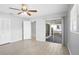 Bedroom featuring wood-look tile, ceiling fan and sliding glass door to backyard at 10519 Wyndcliff Dr, Orlando, FL 32817