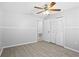 This large bedroom includes wood-look tile floors, large closet, and a ceiling fan at 10519 Wyndcliff Dr, Orlando, FL 32817
