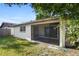 Exterior view of enclosed patio surrounded by a grassy lawn and bamboo at 10519 Wyndcliff Dr, Orlando, FL 32817