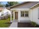 Welcoming front porch with a glass-accented door, new landscaping, and white support columns at 10519 Wyndcliff Dr, Orlando, FL 32817
