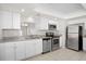 Updated kitchen featuring granite countertops, stainless steel appliances, and ample white cabinetry at 10519 Wyndcliff Dr, Orlando, FL 32817