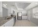 Modern kitchen with granite countertops, stainless steel appliances, and white cabinets at 10519 Wyndcliff Dr, Orlando, FL 32817