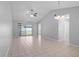 Spacious living room with tile floors, vaulted ceilings, ceiling fan, and sliding glass doors at 10519 Wyndcliff Dr, Orlando, FL 32817