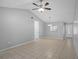 Bright living room featuring tile flooring, vaulted ceiling, ceiling fan, and access to other rooms at 10519 Wyndcliff Dr, Orlando, FL 32817