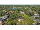 Stunning aerial view of a lush, tree-filled neighborhood with a beautiful lake in the background at 1150 Via Salerno, Winter Park, FL 32789