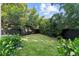 Private backyard with lush green grass and black fence at 1150 Via Salerno, Winter Park, FL 32789