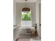 This bathroom features a soaking tub situated near a window providing natural light and a view of the outdoors at 1150 Via Salerno, Winter Park, FL 32789
