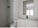 Modern bathroom features glass enclosed shower, elegant vanity with sleek mirror and plumbing fixtures at 1150 Via Salerno, Winter Park, FL 32789