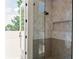 Bright bathroom featuring a glass door shower and light tile at 1150 Via Salerno, Winter Park, FL 32789