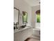 Bright bathroom features double vanity with black hardware and modern mirrors, complemented by a luxurious soaking tub at 1150 Via Salerno, Winter Park, FL 32789