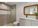 Stylish bathroom featuring a glass-enclosed shower, modern vanity, and a unique mirror at 1150 Via Salerno, Winter Park, FL 32789