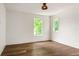 Bright bedroom with hardwood floors, white walls, and natural light from the two windows at 1150 Via Salerno, Winter Park, FL 32789