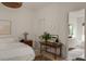 Bright bedroom with hardwood floors, neutral walls, vintage desk, and ensuite bathroom at 1150 Via Salerno, Winter Park, FL 32789