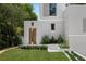 Charming home entrance with unique wood door, complemented by manicured greenery, offering an inviting curb appeal at 1150 Via Salerno, Winter Park, FL 32789