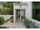 Cozy home entrance with French doors leading to a tranquil stone garden path and lush greenery at 1150 Via Salerno, Winter Park, FL 32789