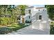 Beautiful white stucco house with two-car garage, perfectly manicured lawn, and mature trees at 1150 Via Salerno, Winter Park, FL 32789