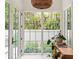 Bright entryway with natural light streaming through the glass doors, showcasing a view of the lush garden at 1150 Via Salerno, Winter Park, FL 32789