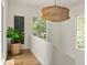Bright hallway with natural light, a large indoor plant, and a unique hanging lamp at 1150 Via Salerno, Winter Park, FL 32789