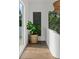Bright hallway with natural light, a large indoor plant, and a black wall hanging at 1150 Via Salerno, Winter Park, FL 32789