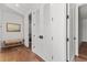 Bright hallway with hardwood floors, white shaker doors, and a cozy bench at 1150 Via Salerno, Winter Park, FL 32789