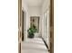 Hallway features white walls, wooden doors, and a decorative mirror with greenery at 1150 Via Salerno, Winter Park, FL 32789