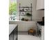 Bright kitchen with white countertops, white cabinets, shelving, and stainless steel appliances at 1150 Via Salerno, Winter Park, FL 32789