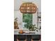 Bright kitchen boasts a wicker light fixture, an island with breakfast seating, and a large window view at 1150 Via Salerno, Winter Park, FL 32789