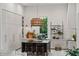 Modern kitchen with island, counter seating, and custom lighting fixture at 1150 Via Salerno, Winter Park, FL 32789