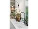 White kitchen sink with black faucet and a view to the backyard window at 1150 Via Salerno, Winter Park, FL 32789