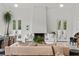 An open living space with a fireplace, neutral couches, and large bright windows at 1150 Via Salerno, Winter Park, FL 32789