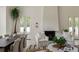 Bright living room showcasing a fireplace, neutral couches, and a dining area near large windows at 1150 Via Salerno, Winter Park, FL 32789